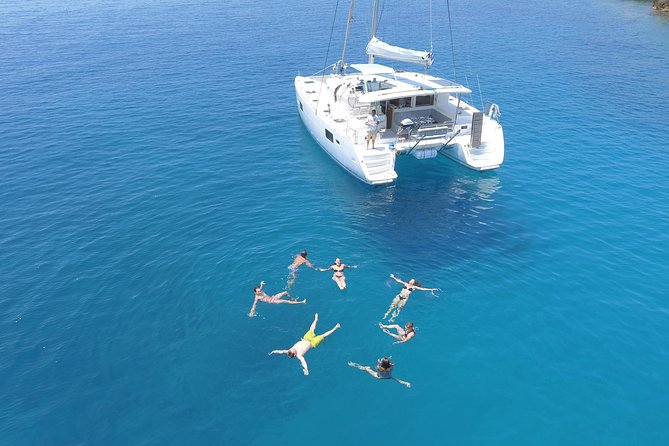 Athens Private Luxury Catamaran Cruise with Traditional Greek Meal and BBQ - Two swimming stops, snorkeling gear, and the towel-and-goggles rhythm